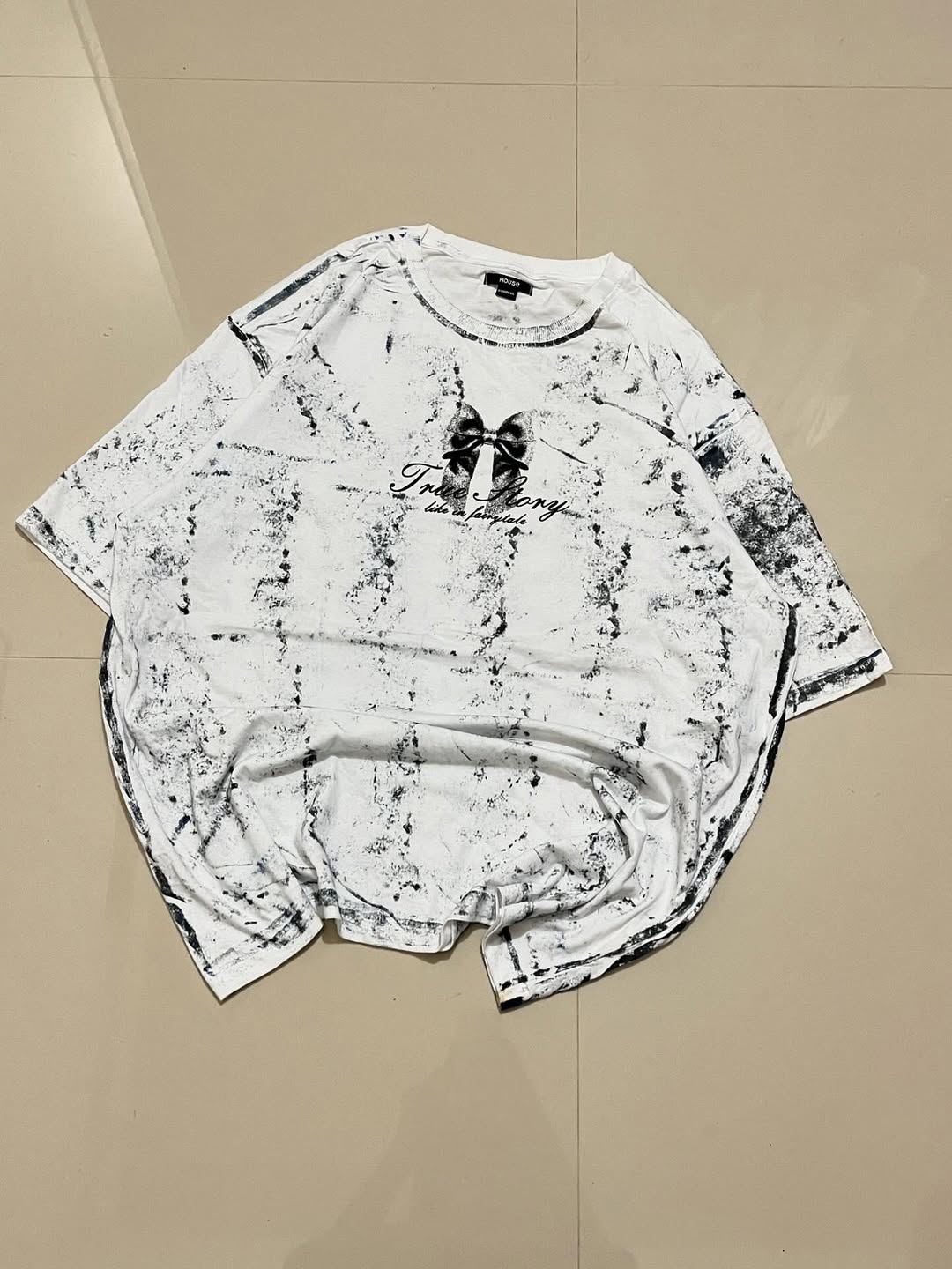 Horse oversized white tee with “True Story” text and small bow graphic on distressed wash
