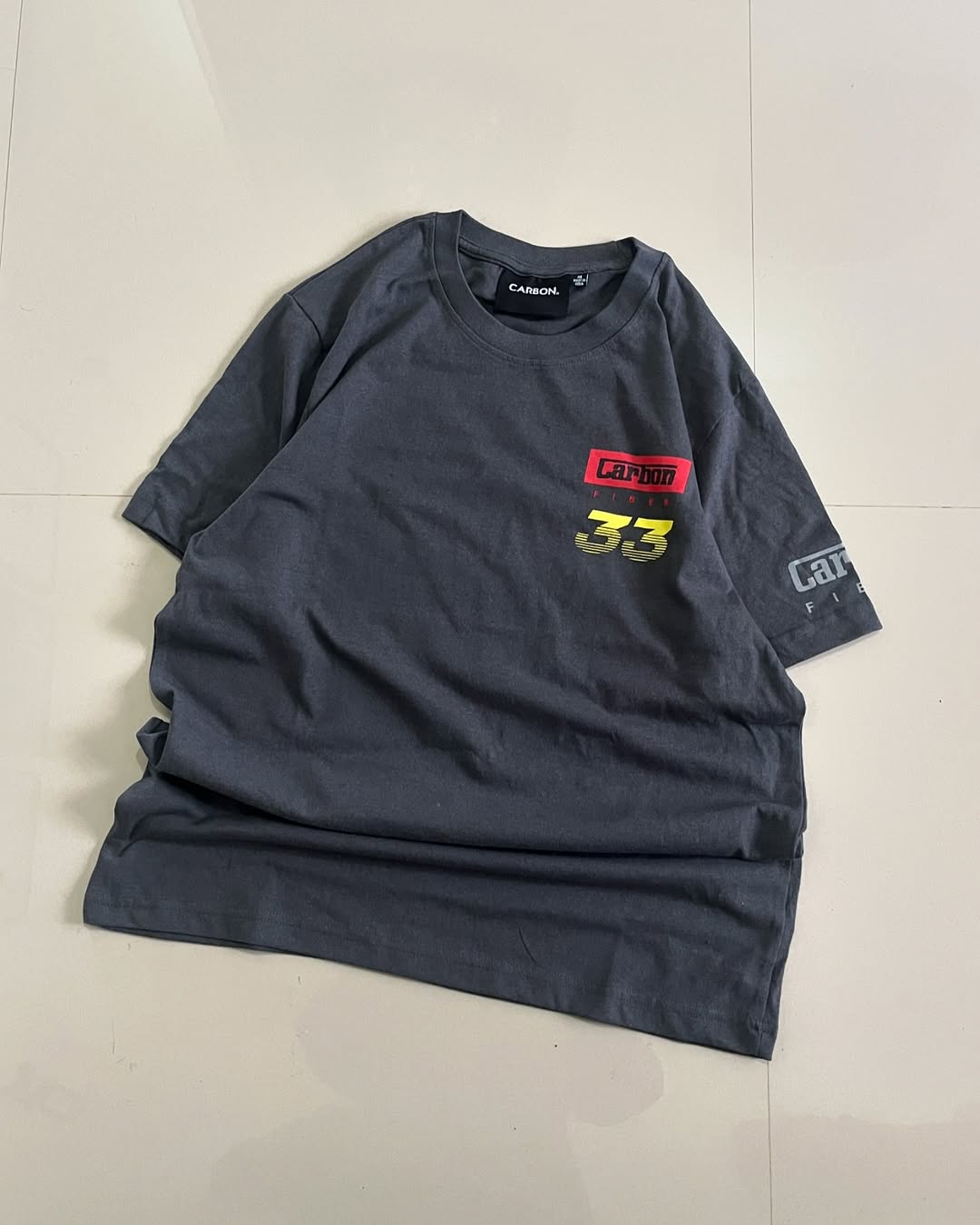 Front Black oversized t-shirt with colorful thermal helmet graphic and Carbon Fiber branding