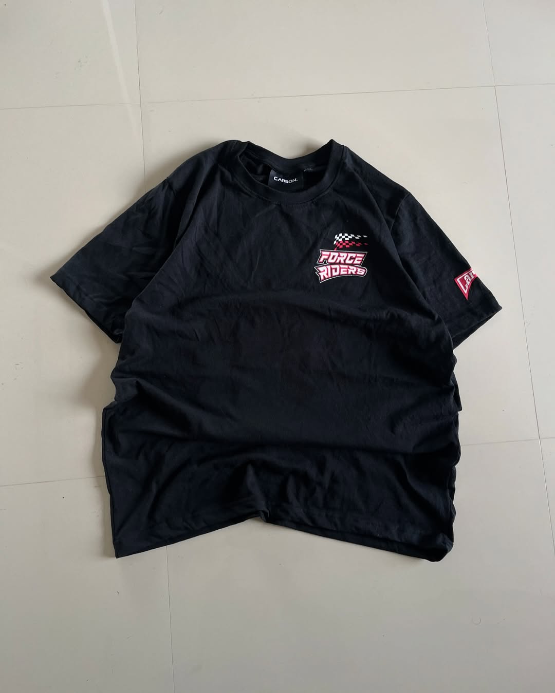 Front view of black oversized Force Riders tee featuring colorful Formula 1 car and checkered flag design by Junk Fits

