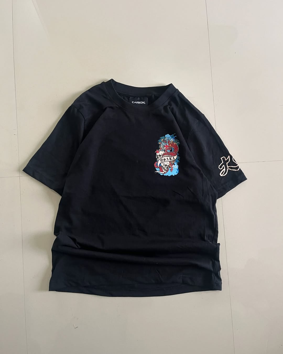Front view of Black oversized t-shirt with red dragon and skulls graphic, Osaka banner – bold streetwear by Junk Fits


