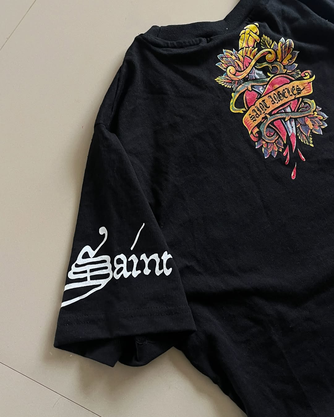 Back view of Junk Fits Saint Angeles Graphic Tee with bleeding heart and Saint branding