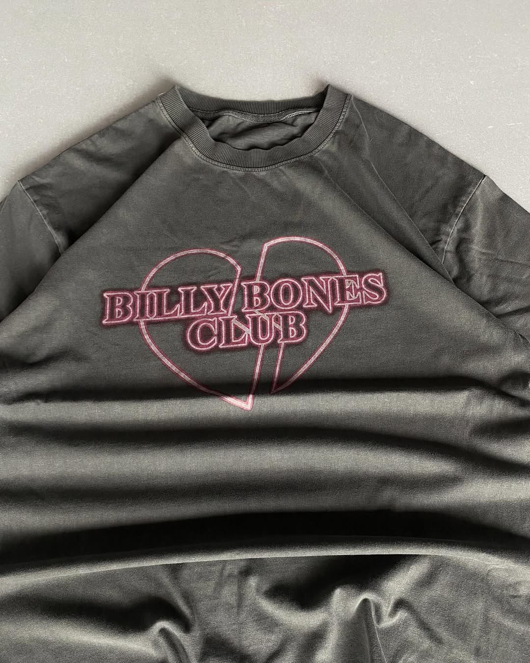 Junk Fits Billy Bones Club T-Shirt with pink broken heart print on washed black fabric Closeup