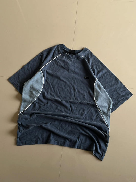 JUNKFITS oversized washed blue t-shirt with light blue mesh side panels and white piping, front view.
