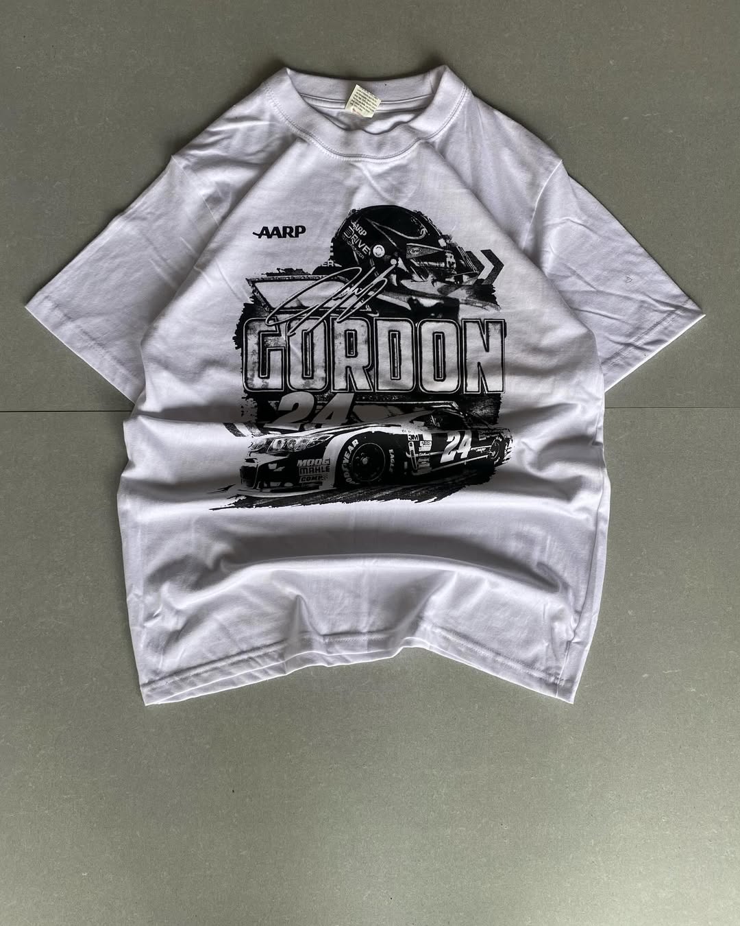 Front view of JunkFits white t-shirt with racing car, helmet, and Gordon 24 graphic print