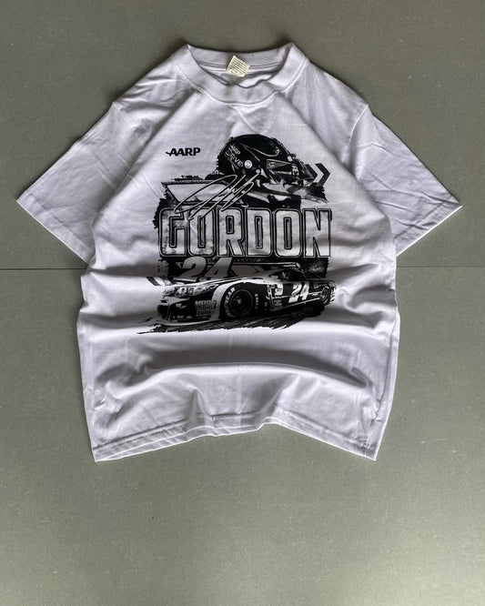 Front view of JunkFits white t-shirt with racing car, helmet, and Gordon 24 graphic print