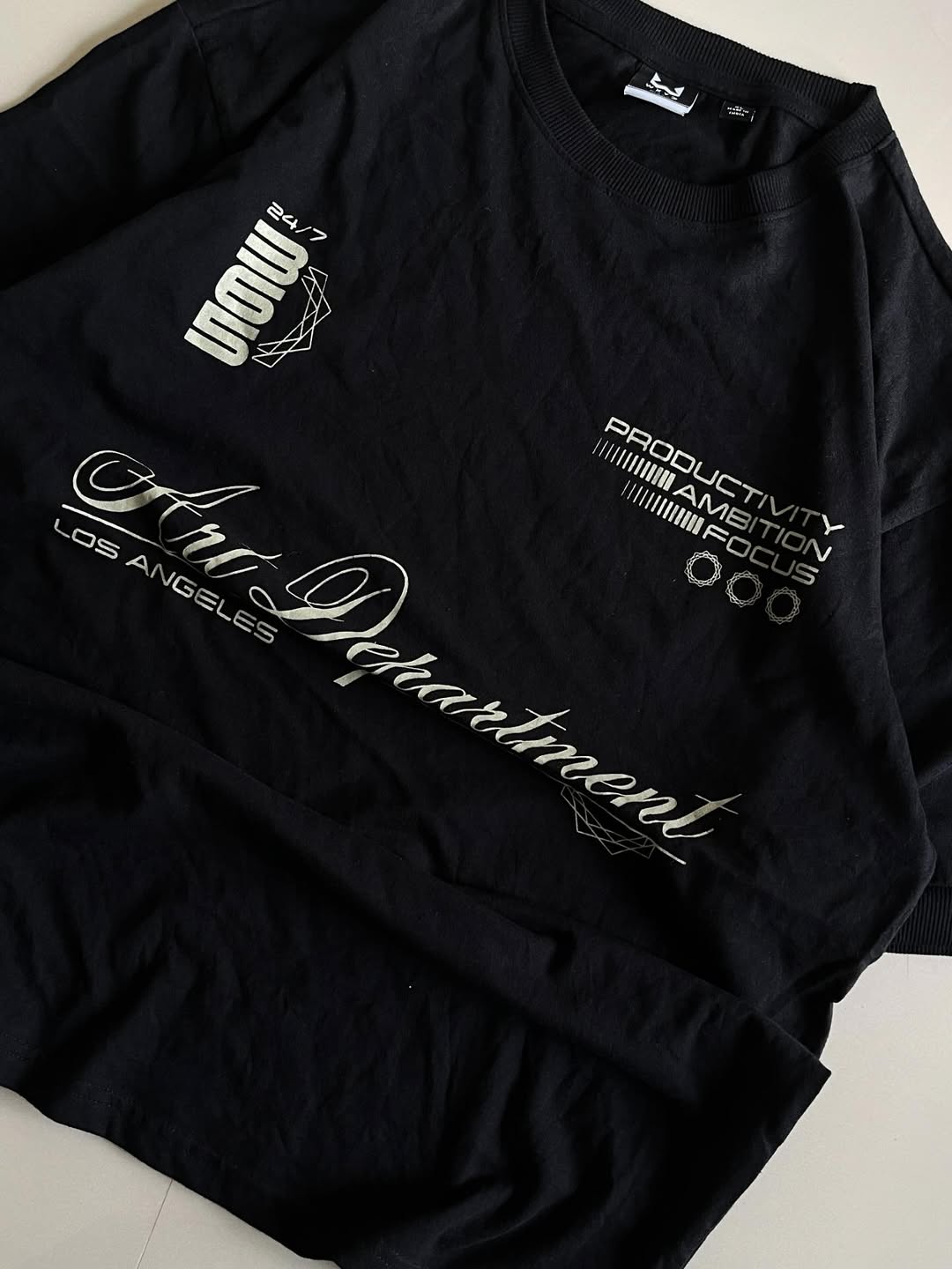 JUNKFITS black t-shirt closeup view with clean finish and oversized silhouette.