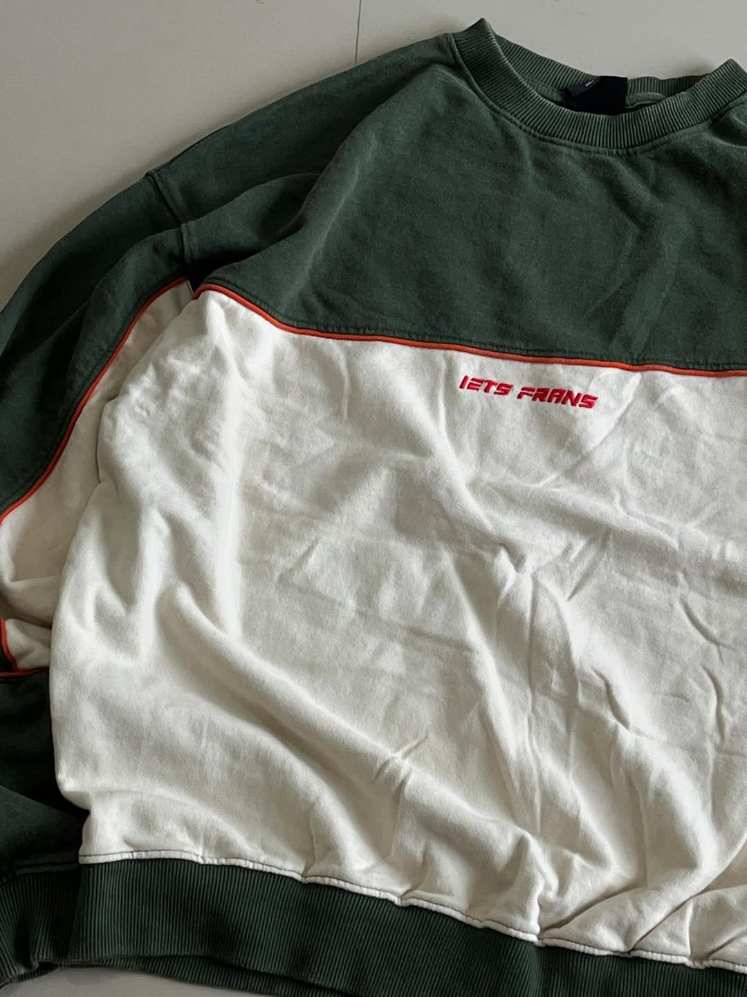 JUNKFITS oversized sweatshirt closeup view highlighting forest green colorblock and relaxed fit.
