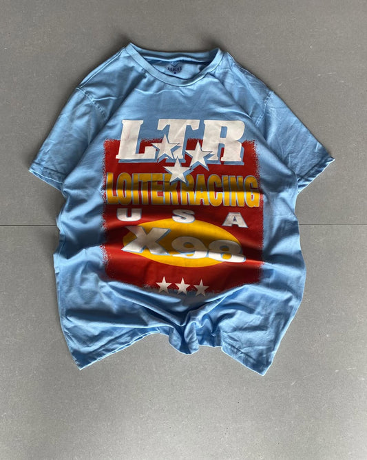 Front view of JunkFits sky blue t-shirt with Loiter Racing USA X98 retro graphic print
