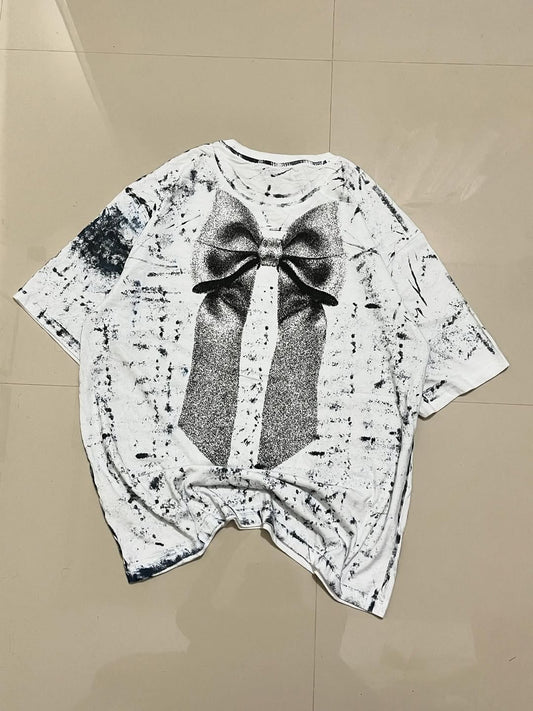 Horse oversized white tee featuring large glitter-style bow on distressed monochrome fabric