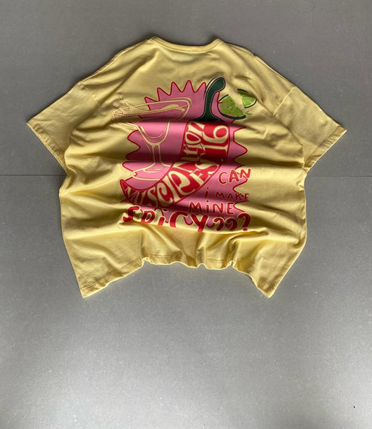 Back view of JunkFits oversized yellow t-shirt with cocktail glass, chili pepper, and lime graphic