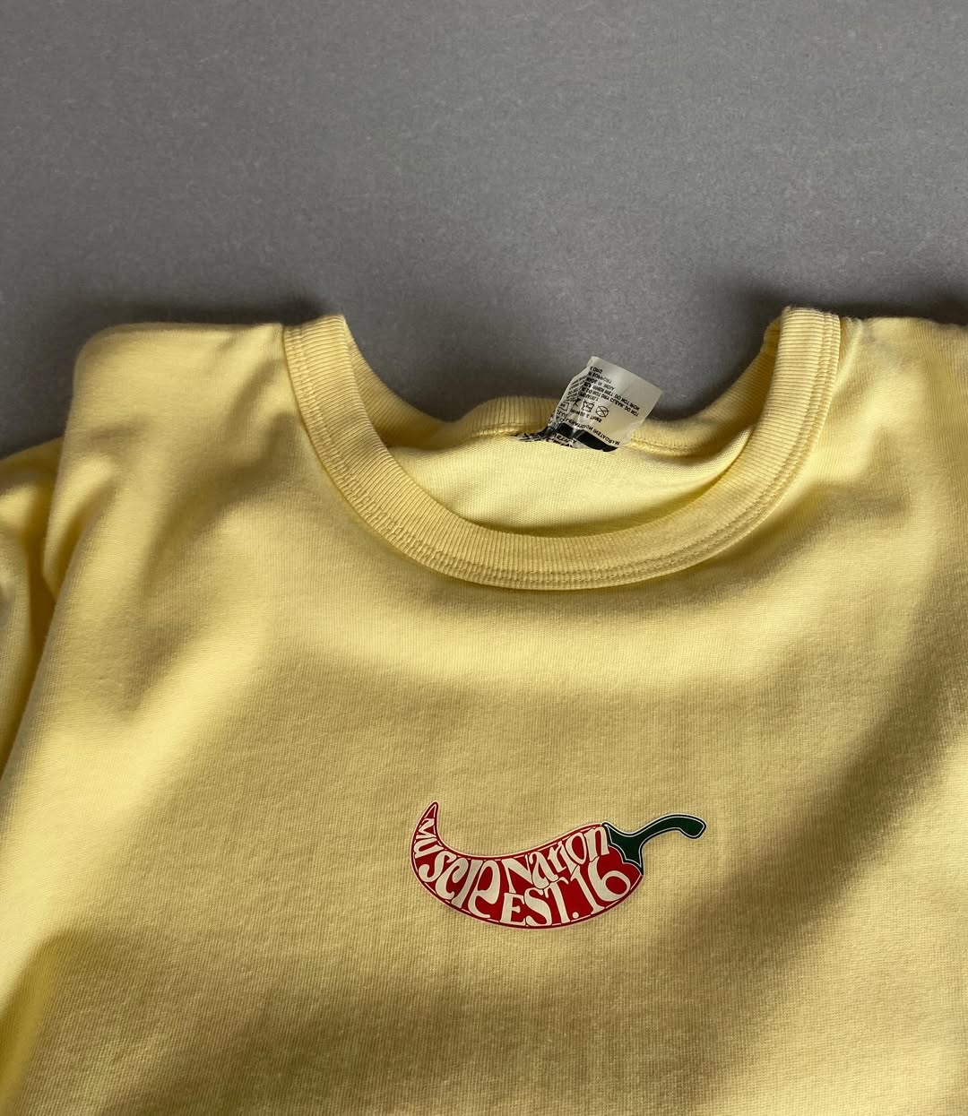 Front view of JunkFits oversized yellow t-shirt with spicy cocktail theme