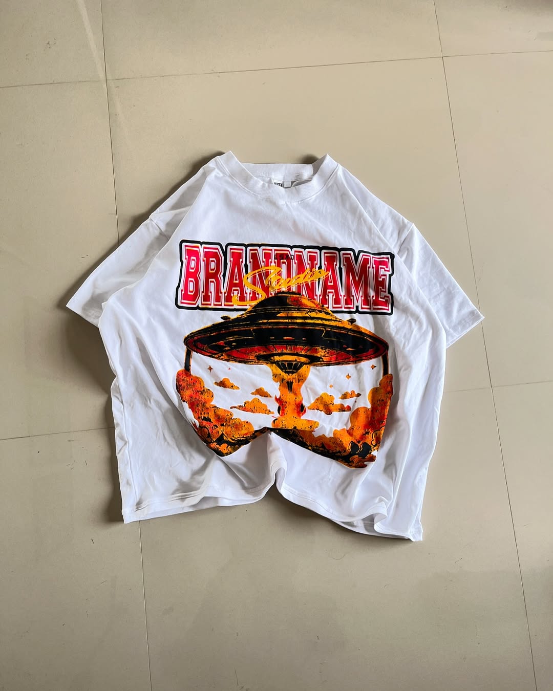 Junk Fits white oversized t-shirt with UFO explosion graphic and bold varsity-style 