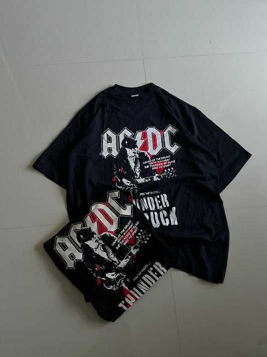 Black JUNKFITS t-shirt featuring AC/DC logo, Angus Young artwork, and Thunderstruck lyrics

