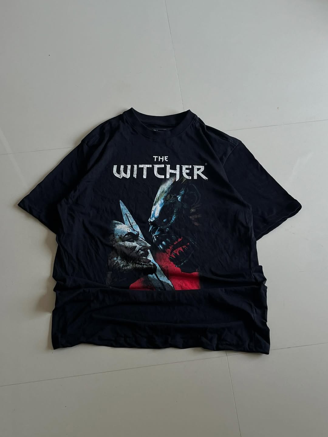 Black JUNKFITS t-shirt featuring The Witcher Wild Hunt artwork with monster designs and logo

