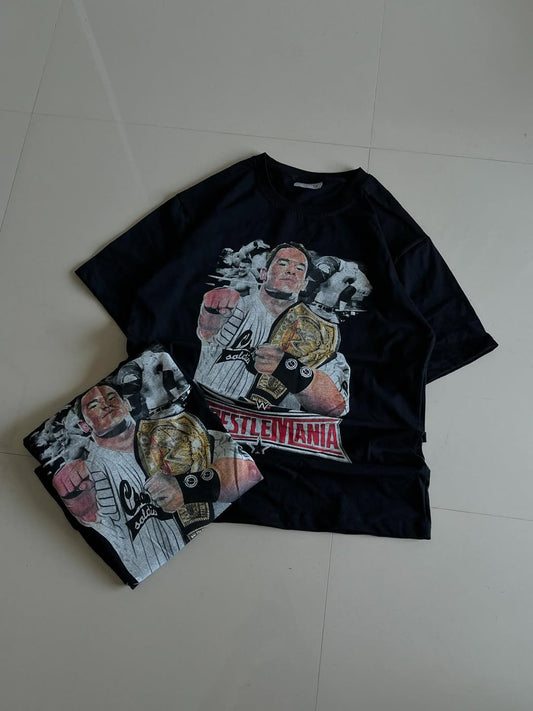 Black JUNKFITS t-shirt featuring a champion wrestler graphic with championship belt and WrestleMania logo

