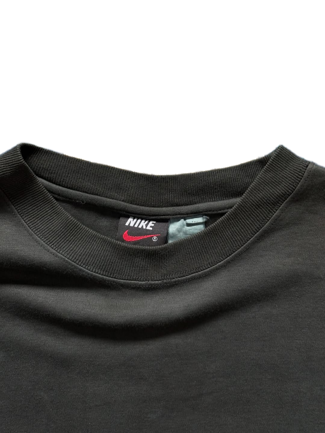 Tag close-up of Nike Tennis Vintage Tee showing size and branding


