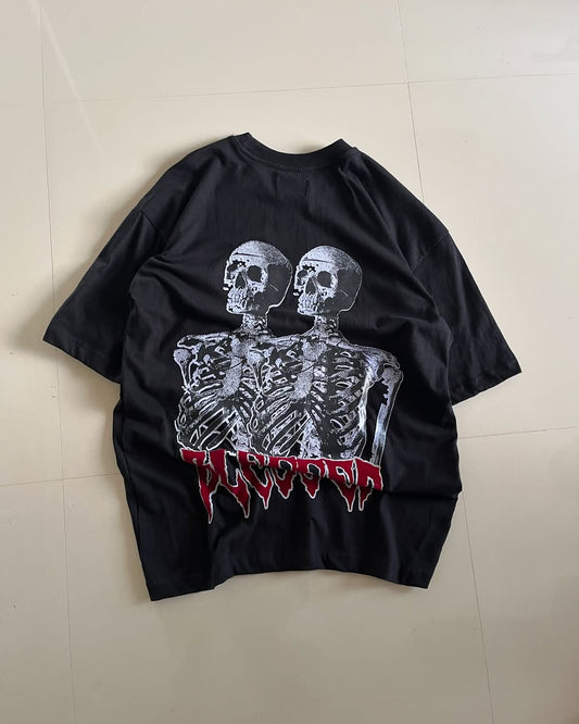 Oversized black t-shirt with twin skeleton graphic and red gothic-style lettering on the back

